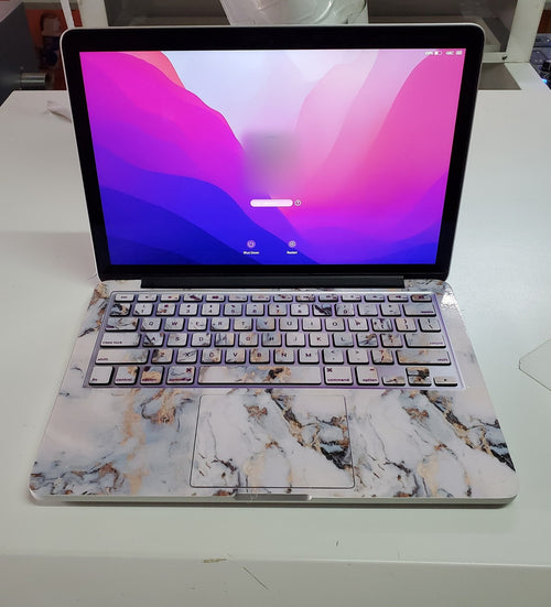 Amber Vein Marble laptop skin on a MacBook keyboard