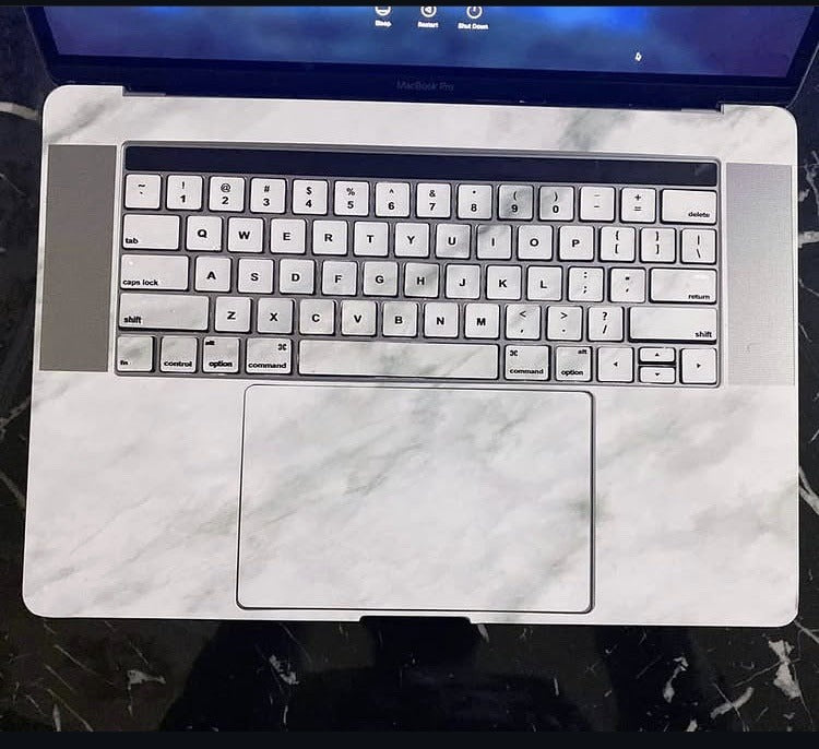 Carrara Grey laptop skin on a MacBook keyboard