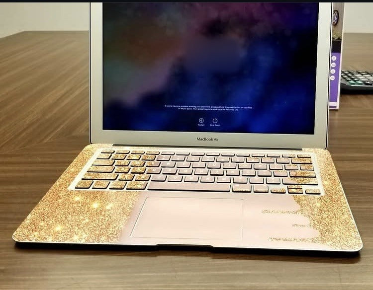 Gold Glitter Drip laptop skin on a MacBook keyboard