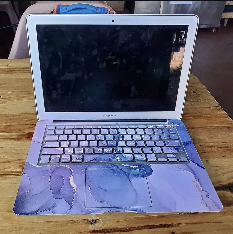 Lilac Haze Marble laptop skin on a MacBook keyboard