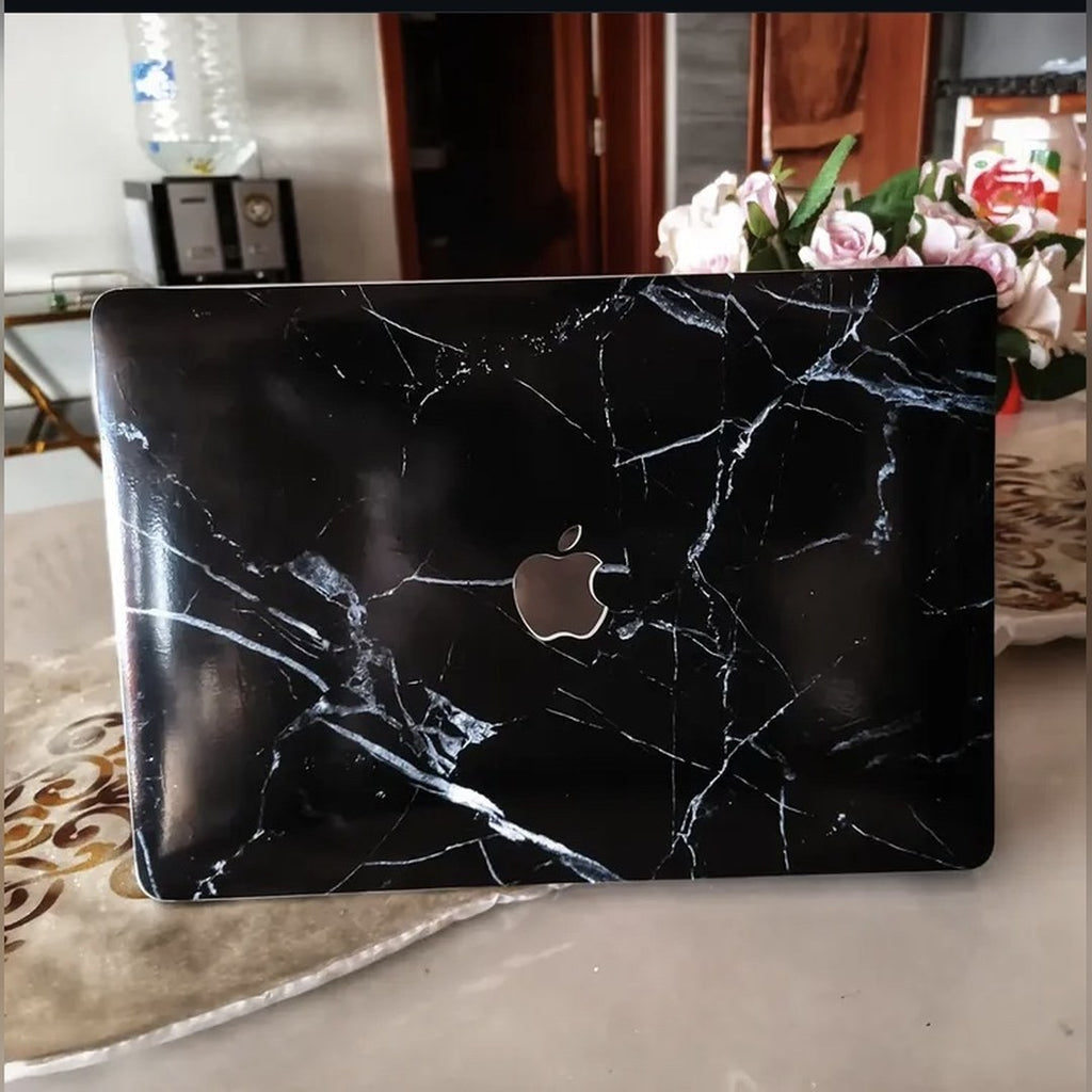 Midnight Marble laptop skin on a MacBook lid