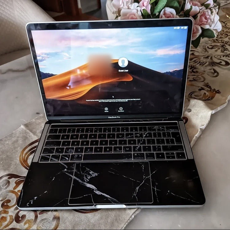 Midnight Marble laptop skin on a MacBook keyboard