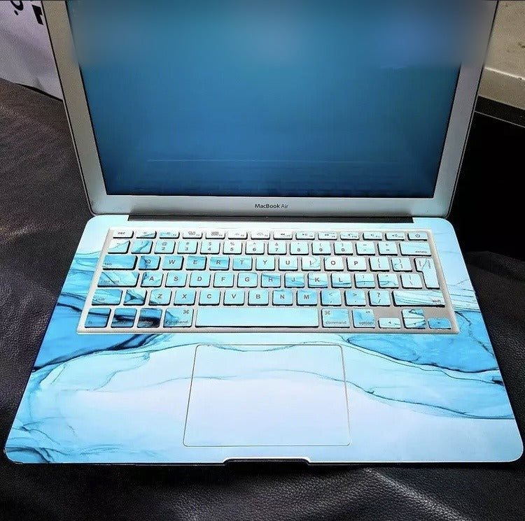 Teal Tide Marble laptop skin on a MacBook keyboard