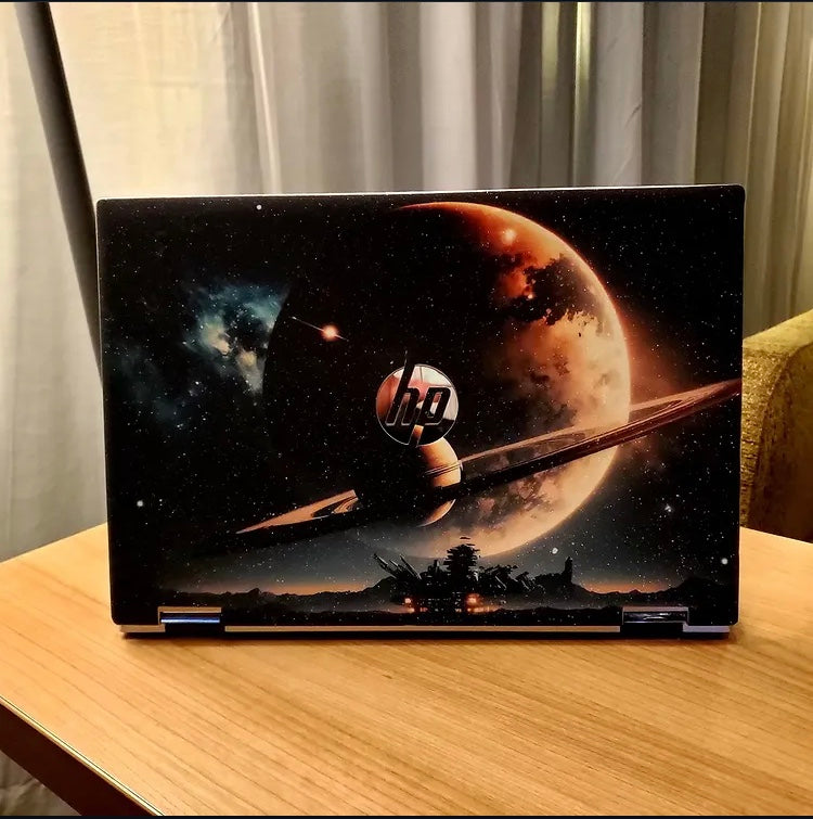Planet Rise laptop skin on an HP lid