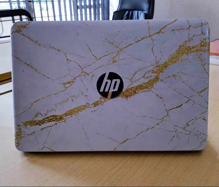 White Gold Marble laptop skin on an HP lid
