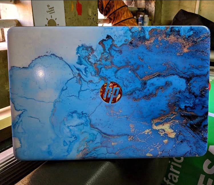 Ocean Gold Marble laptop skin on an HP lid