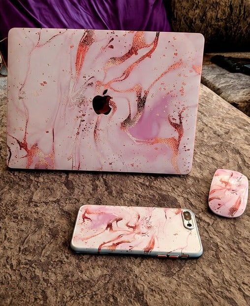 Pink marble MacBook skin with matching phone and mouse skins